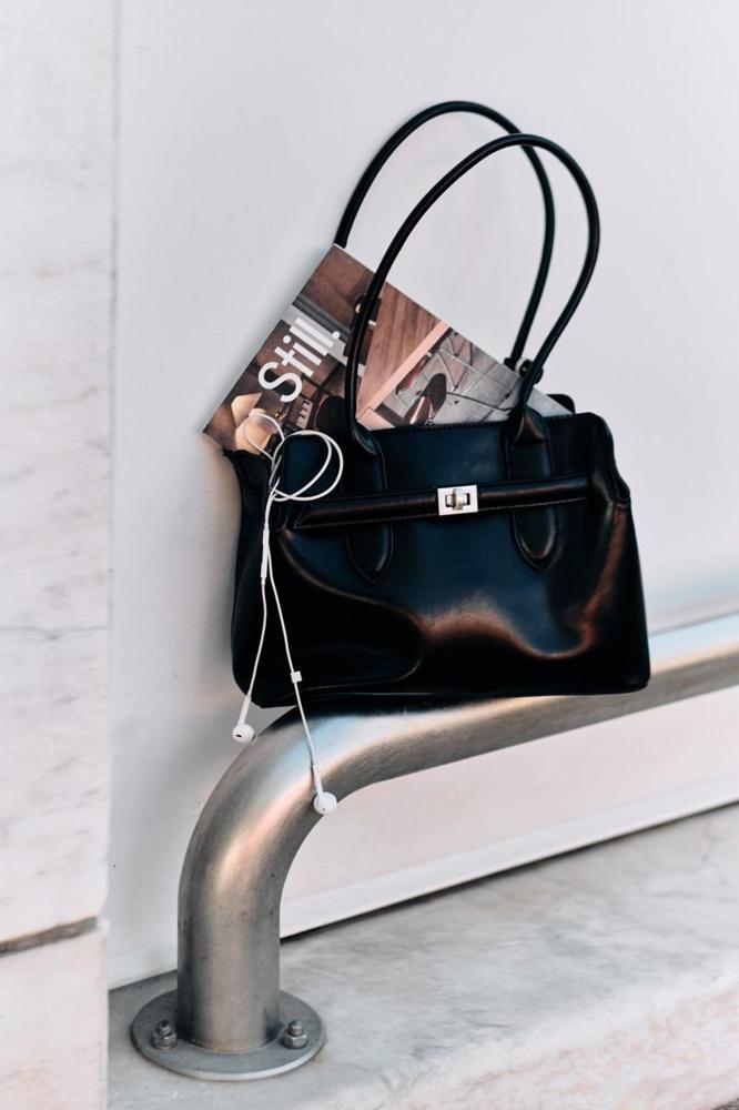 Still. tucked into a black leather handbag